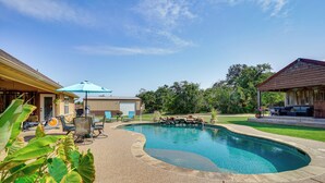 A backyard with a swimming pool, patio furniture, and a covered seating area. - 4 Mi to Dtwn: Home w/ Pool in Stephenville! (Stephenville)