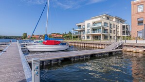 A marina with a dock and a sailboat. - "Nordlicht" Vacation Rental in the Island Town of Malchow (Malchow)