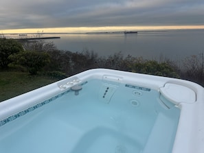 A hot tub with a view of a calm body of water and distant land. - Water Edge Coast-Guard Cottage-Panorama View- (Port Angeles)