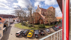A view of a church with a parking area in front.