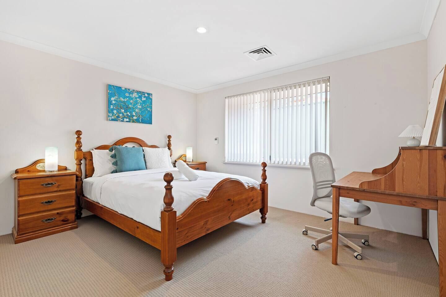 This bright and inviting bedroom offers a perfect blend of comfort and functionality, ideal for both relaxation and productivity.
