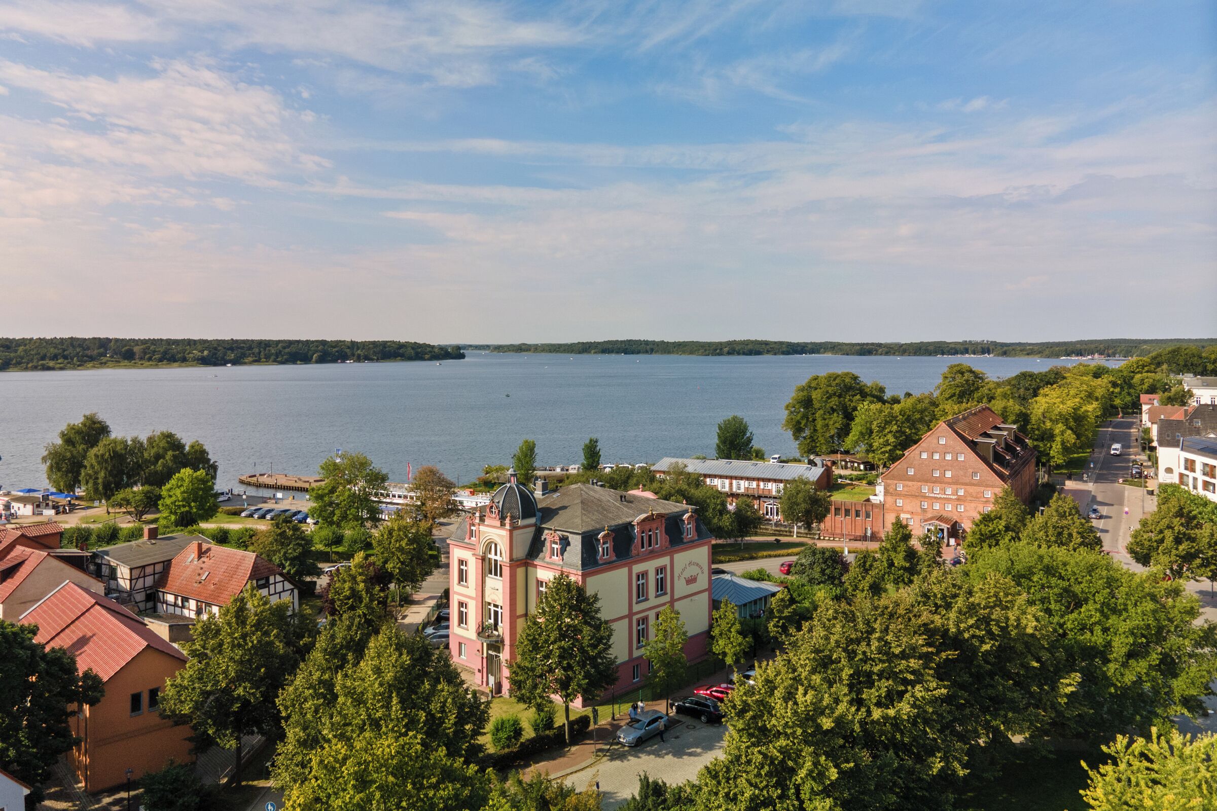A lakeside town with historic buildings, a prominent church, and a view of the lake.