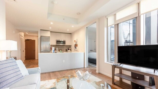 A modern apartment with a living room, kitchen, and dining area. - Luxury & Bright Apt Downtown Seaport (Boston MA)