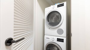 A laundry room with two stacked front-loading washing machines.
