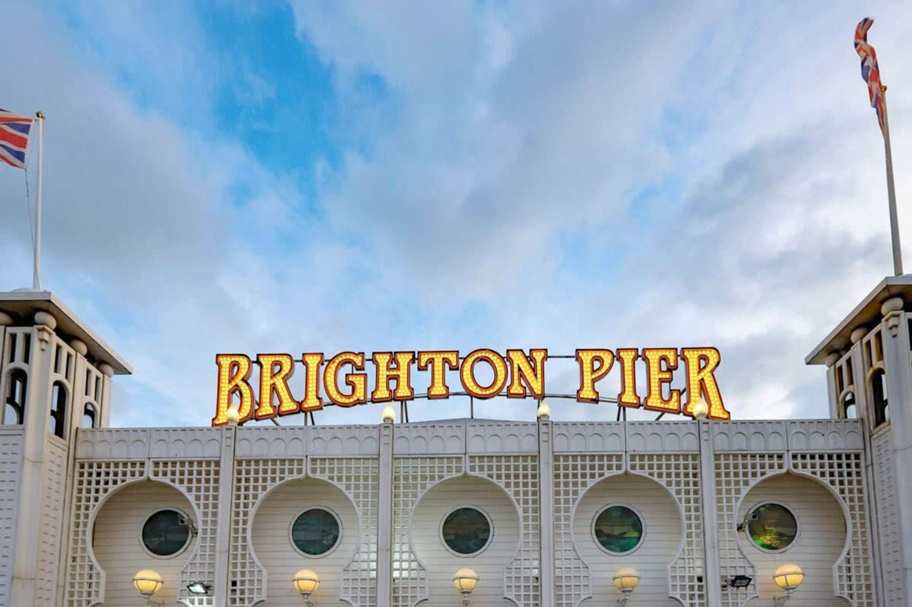 The exterior of Brighton Pier with the name 'BRIGHTON PIER' prominently displayed.