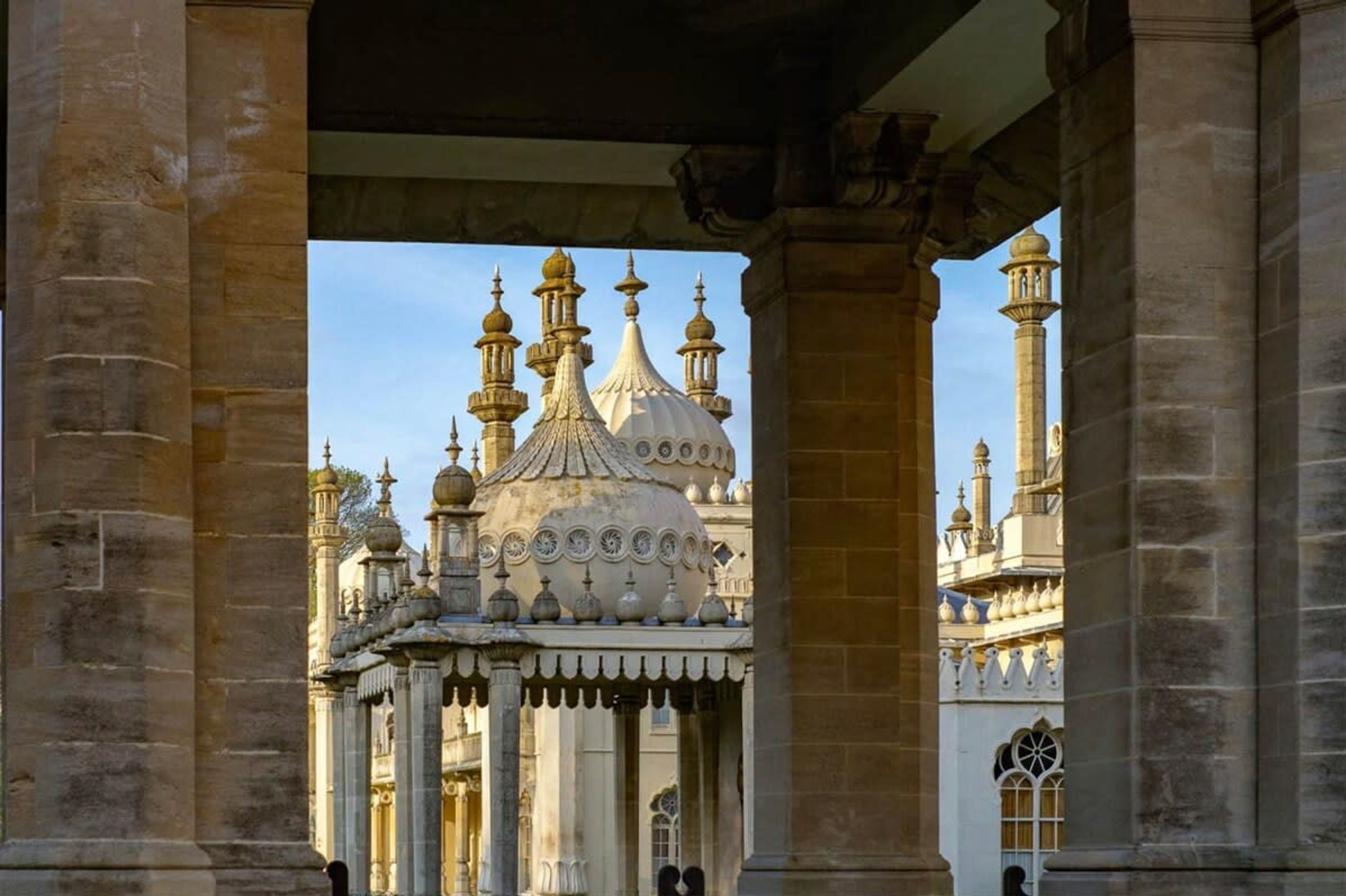 A historical building with ornate domes and minarets, featuring a central dome with multiple smaller domes and a large central dome.