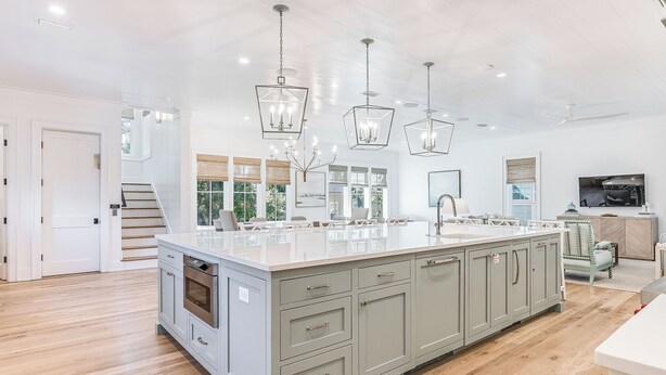 A spacious kitchen with a large island, light wood flooring, and modern pendant lighting. - Mischievous Mermaid|Easy Beach Access|Private Pool|Game Room|Golf Cart (Seagrove Beach)