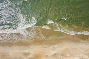 A beach with waves crashing onto the shore.