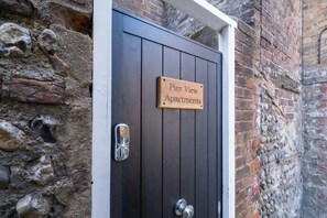 Enter the charming Pier View Apartments through this historic stone entrance.
