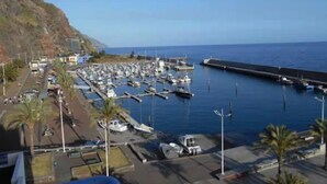 A marina with boats docked, a pier, and buildings in the background. - Calheta Ocean View Retreat - Casa Santana (Estreito da Calheta)