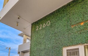 Stylish building with a lush green wall and modern design.