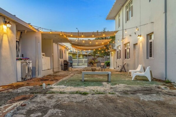 Relax in the serene courtyard, surrounded by comfortable seating and string lights.