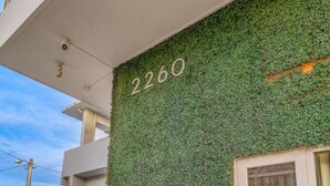 A building facade with a green wall and the number 2260.
