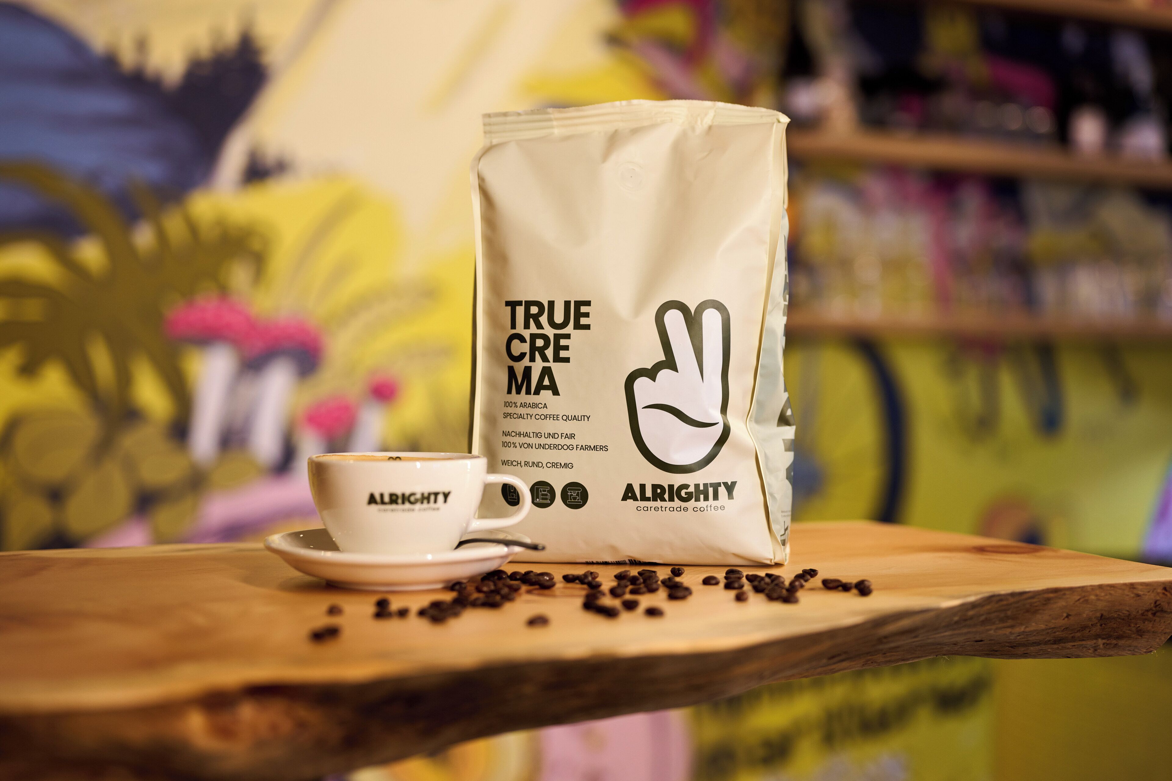 A coffee cup and a bag of coffee beans on a wooden table.