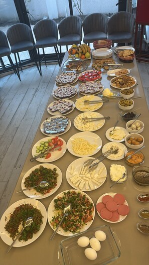 A buffet table with various dishes and a glass container of eggs. - Pacis Antakya (Antakya)