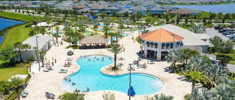 A resort with a large central pool, multiple smaller pools, and a water park.