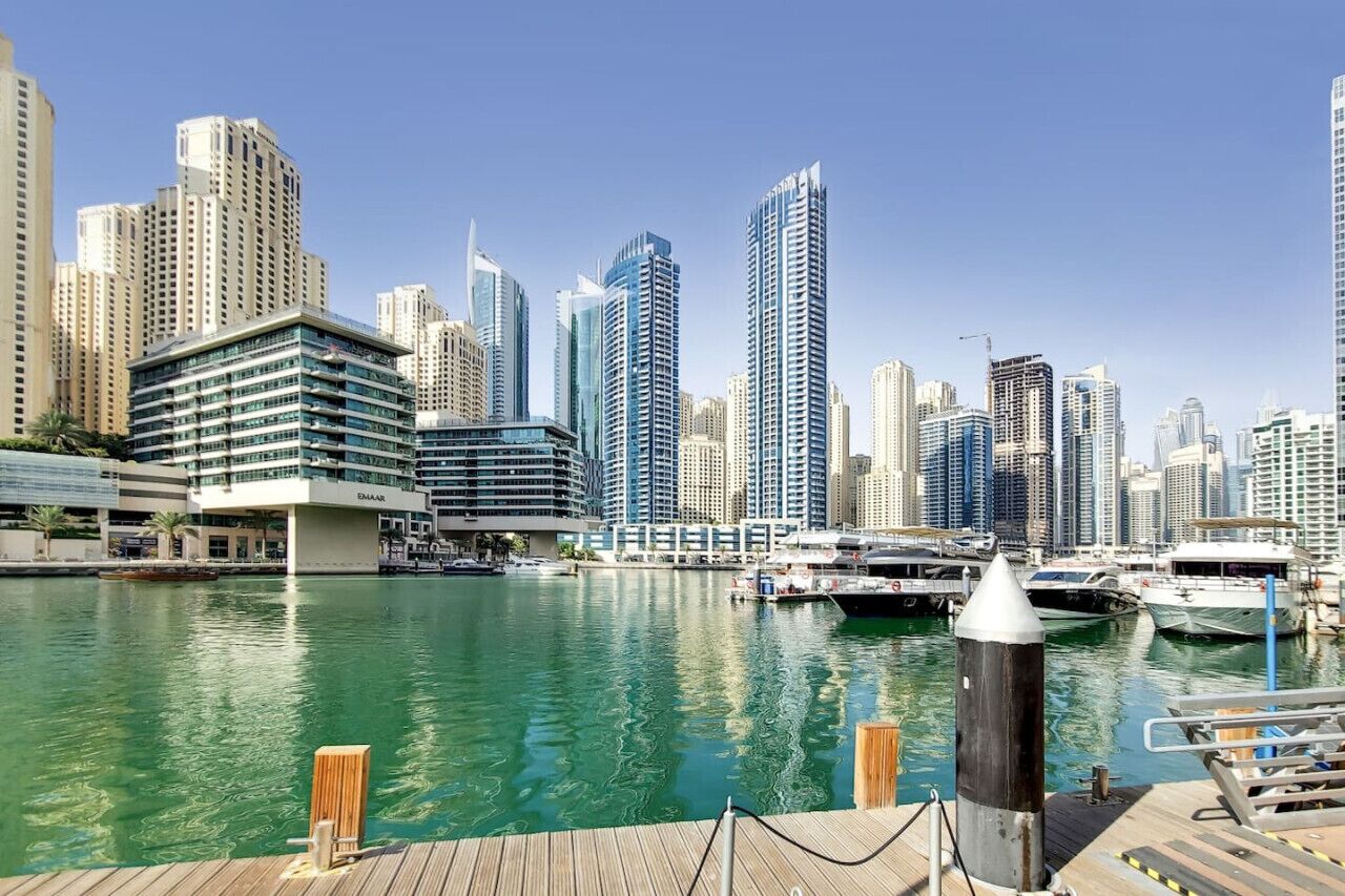 A marina with modern high-rise buildings in the background.