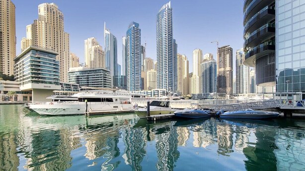 A marina with yachts docked, surrounded by high-rise buildings. - Bay Central West - Spacious Studio in the Dubai Marina (Dubai Marina)