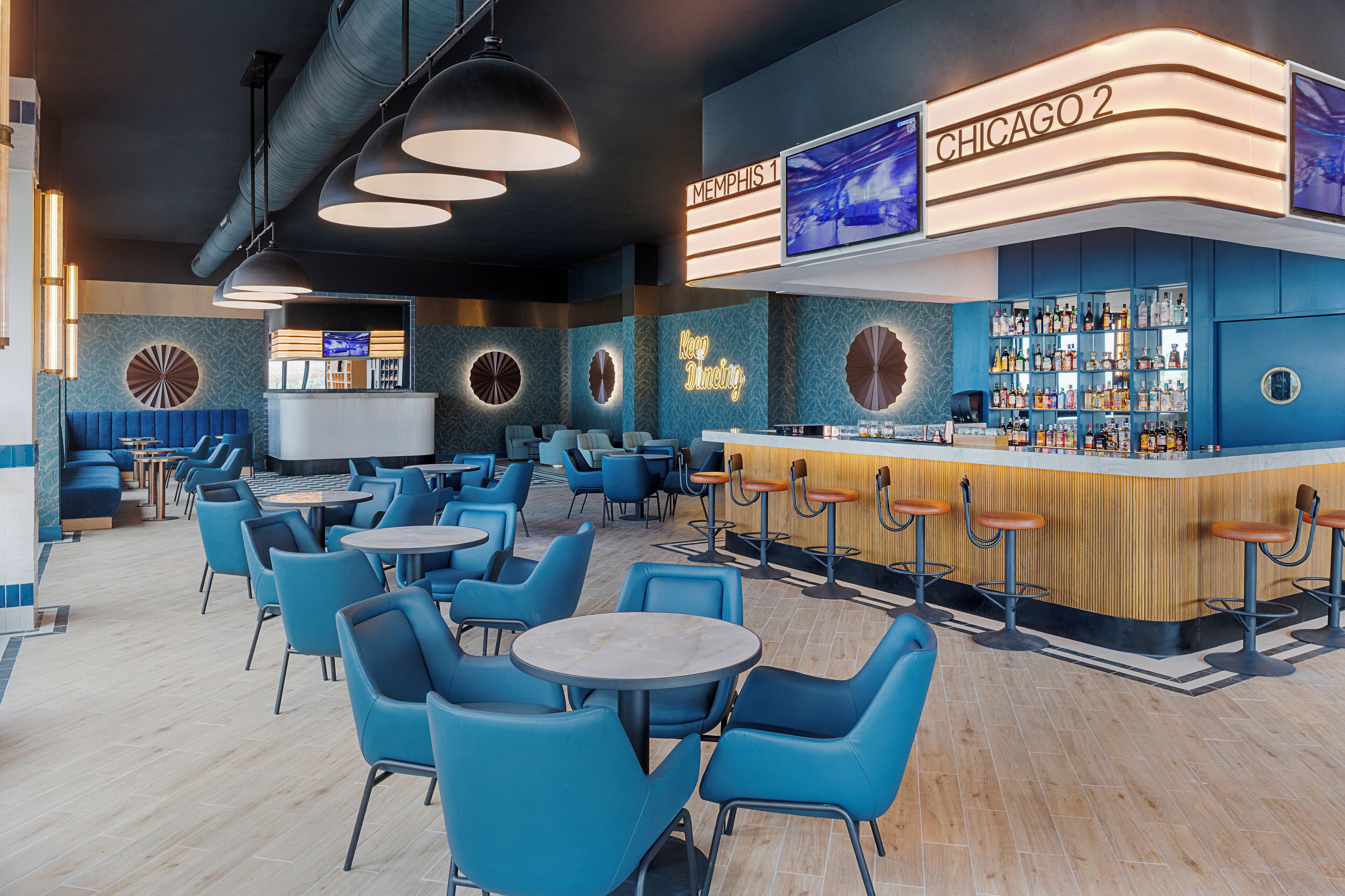A bar area with blue seating and a bar counter.