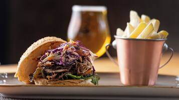 A sandwich with coleslaw and fries on a plate.
