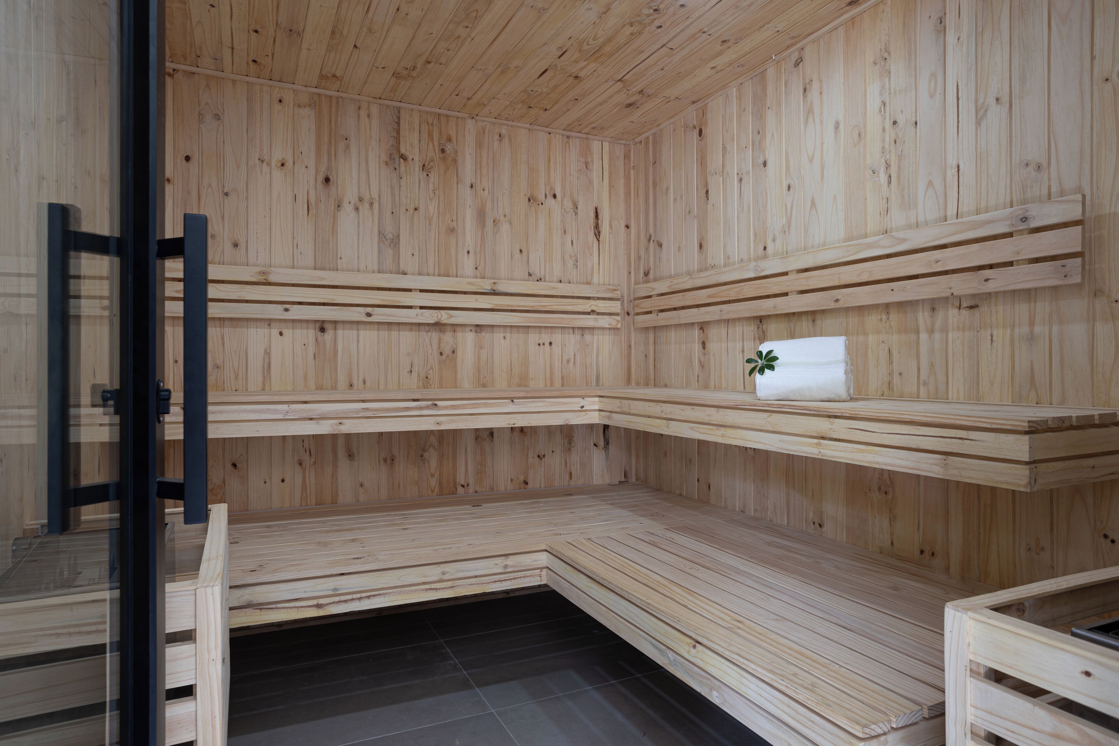 A sauna with wooden benches and a towel on one of the benches.