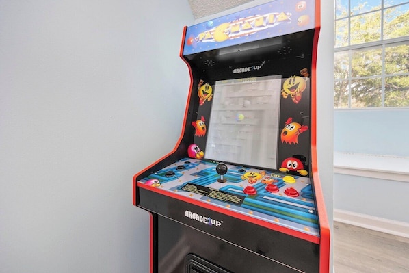 Une borne d’arcade avec des personnages aux couleurs vives et un joystick.