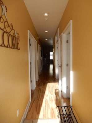 Stunning hallway with white doors and a welcoming sign.