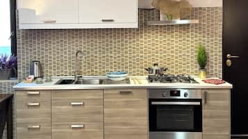 Deluxe Condo, Balcony, City View | Private kitchen | Full-sized fridge, microwave, oven, stovetop