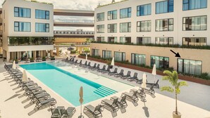 A modern hotel with a rooftop pool, multiple balconies, and a clear sky. - Probar Suites Punta Cana (Punta Cana)
