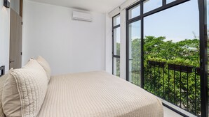 A bedroom with a large window, a ceiling fan, and an air conditioning unit. - DANNY HOUSE 4 (Puerto Vallarta)