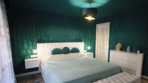 A bedroom with a bed, a nightstand, a dresser, and a bench. - The Luxe Haven (Cerdanyola del Vallès)