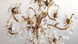 A chandelier with multiple arms and crystal decorations.