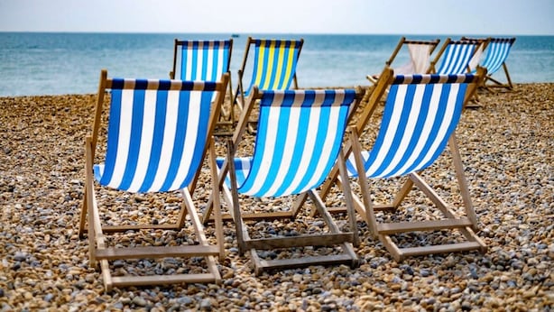 Beach chairs with blue and white stripes on a pebbled beach. - Host Stay Montpelier Sanctuary (Brighton)