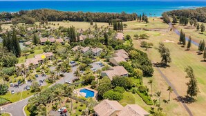 A residential area with houses, a swimming pool, and a golf course. - Hale Kai - Large Enclosed Lanai - Sleeps 2 (Kahuku)