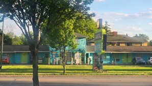A motel with a green facade, a visible signboard, and a parking lot with cars. - #33 Nice stay near Bexley and Capital University (Columbus)