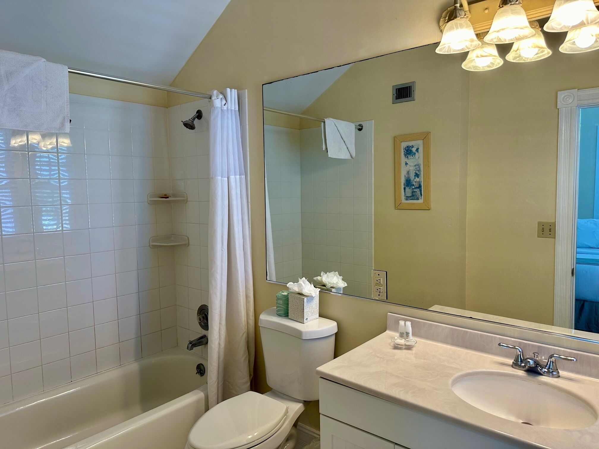 A bathroom with a bathtub, toilet, and sink.