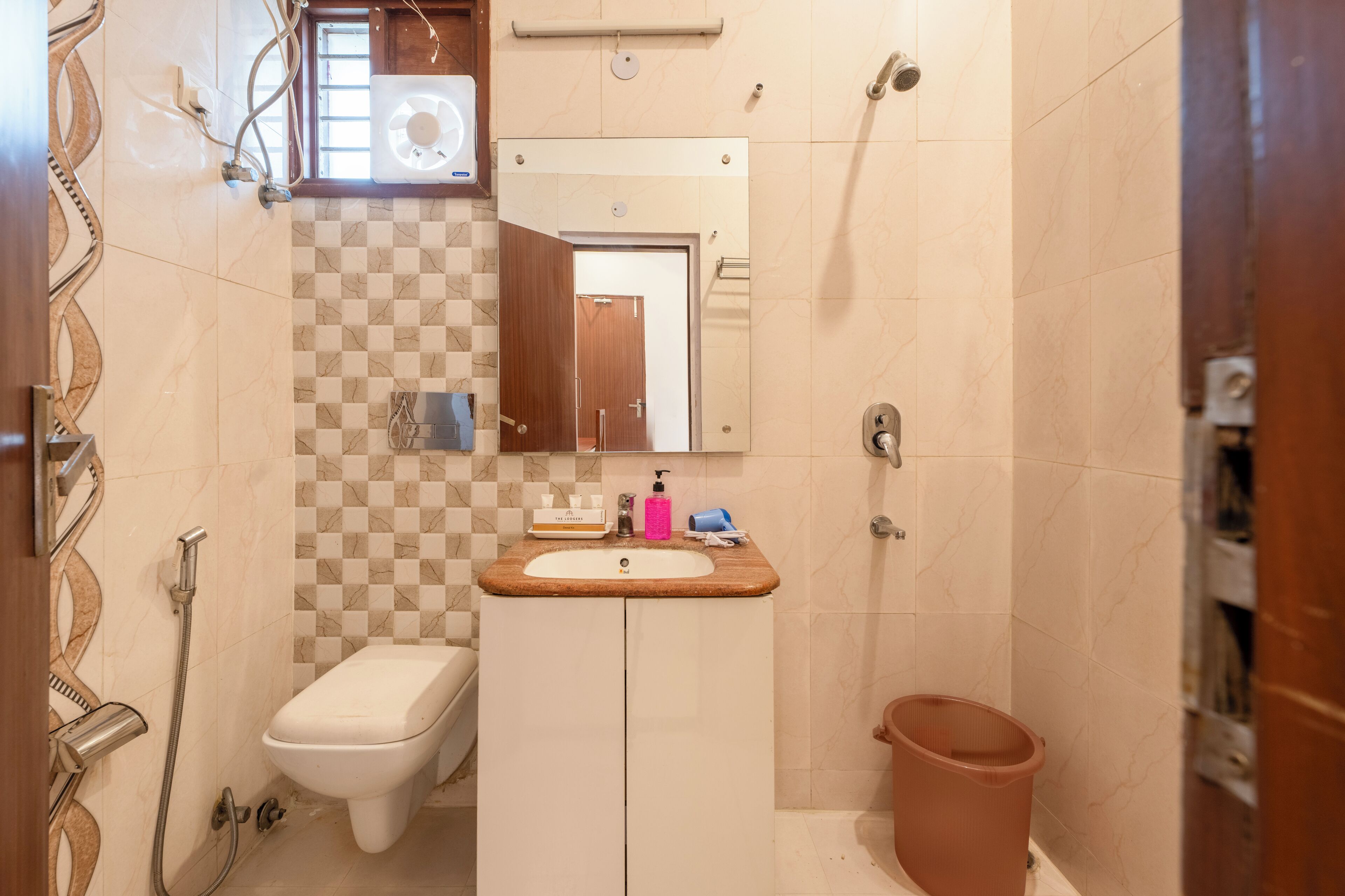 A bathroom with a toilet, sink, and shower.