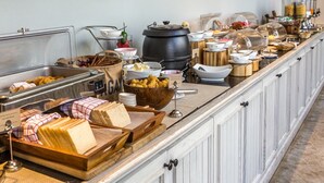 A buffet setup with various food items and containers. - The Lodgers Hotel and Banquet Sector 38 (Gurugram)