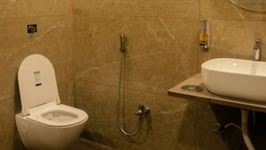 A modern bathroom with a toilet, shower, and sink. - Sandal Wood Villa By 97RoyalVista (Mawal)