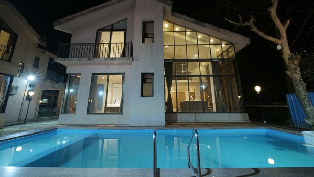A modern two-story building with a swimming pool in front. - Sandal Wood Villa By 97RoyalVista (Mawal)