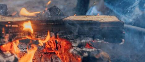 A person roasting marshmallows over a campfire.