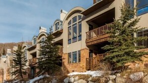 A multi-story building with balconies, large windows, and a stone facade. - 4 bdr Swiss chalet in Solitude, 5 min to lifts (Salt Lake City)