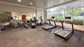 A gym with treadmills, exercise balls, and weight machines. - AWS Holiday Homes - In the Heart of Downtown (Dubai)