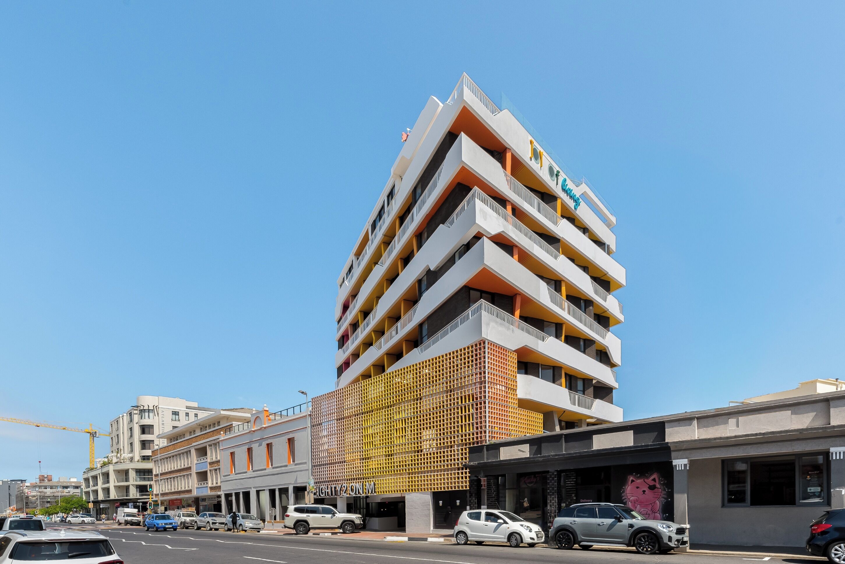 A multi-story hotel with balconies and a distinctive facade.