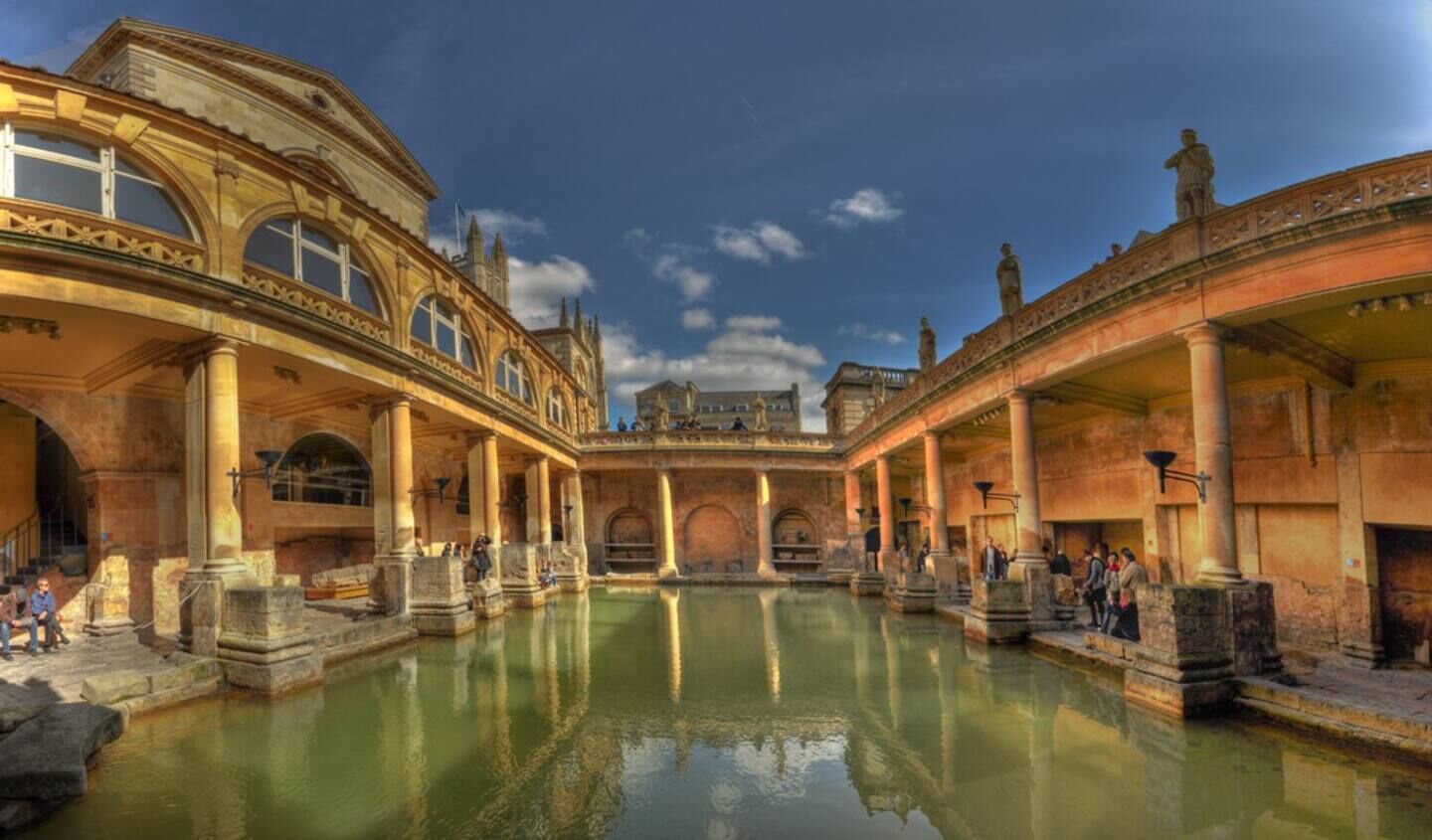 A historic building with a central courtyard and a pool.