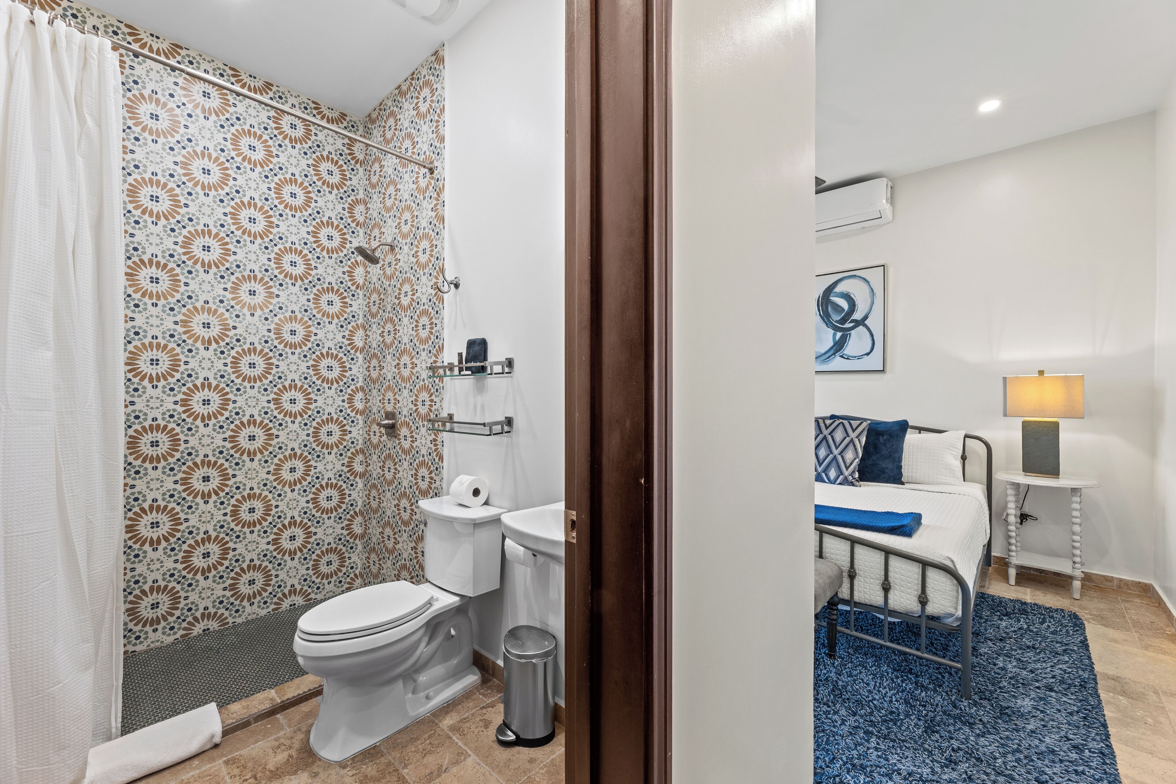 A bathroom with a shower, toilet, and sink.