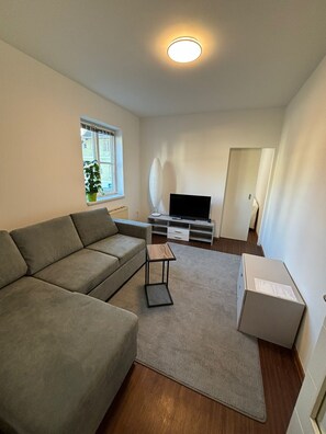 Relax in this stylish living room with a comfortable sofa, flat-screen TV, and a beautiful view.