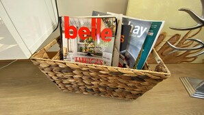 A woven basket containing magazines on a wooden floor. - LUXURY 4 BEDROOM KING BED SPA ARCADE WIFI NETFLIX SLEEPS 10 WITH BOAT PARKING (Portland)