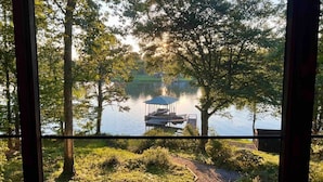 A lakeside view with a dock and a gazebo.