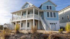 A two-story beachfront house with a balcony and a staircase leading to the upper floor. - Oceanside 7min walk2beach,6BR,Pool,HotTub,Foosball (Corolla)